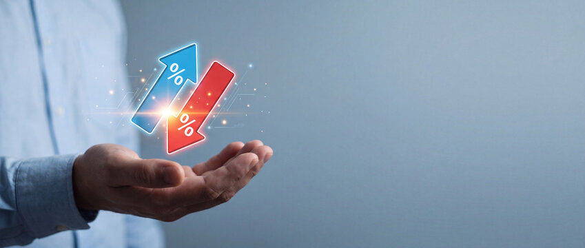 Businessman Holding Virtual Glowing Blue Upward and Red Downward Arrows with Percentage Symbols Representing Interest Rate Fluctuation, Financial Investment Risk, and Economic Change Concept