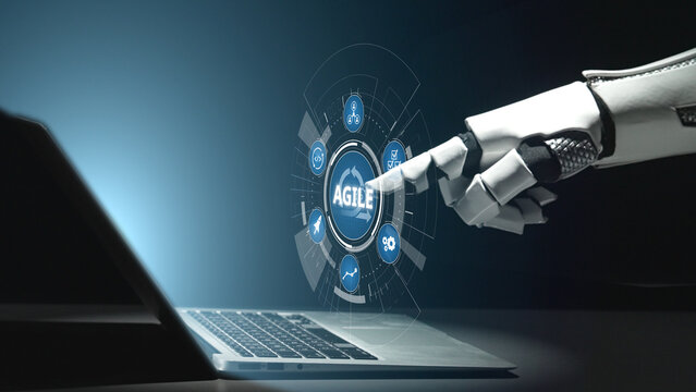 A robotic hand interacts with a laptop screen displaying an agile digital interface, symbolizing the integration of technology and automation in modern workflows. Salient
