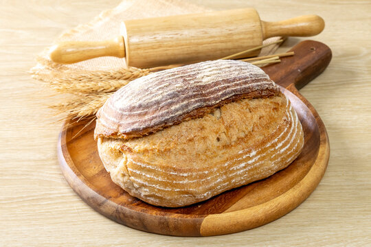 Sliced Sourdough Bread isolated on  Wooden Background, Homemade Bakery Concept