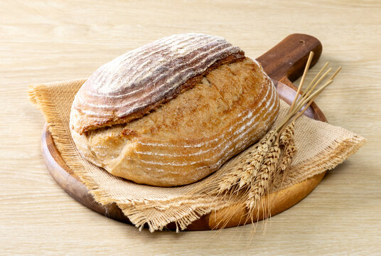 Sliced Sourdough Bread isolated on  Wooden Background, Homemade Bakery Concept