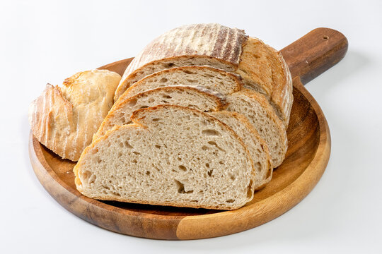A rustic artisan sourdough bread loaf isolated on a clean white background.  The texture of the crust highlights the handcrafted baking process and natural fermentation typical of sourdough bread.
