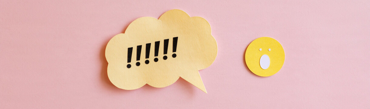 Speech Bubble with Exclamation Marks: A yellow speech bubble filled with bold black exclamation marks sits next to a yellow circle with a white dot, all against a soft pink background.