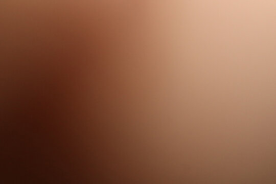 Soft warm brown and beige abstract gradient background with a smooth blurred transition from darker brown to lighter neutral tones, providing generous copy space for background and design applications