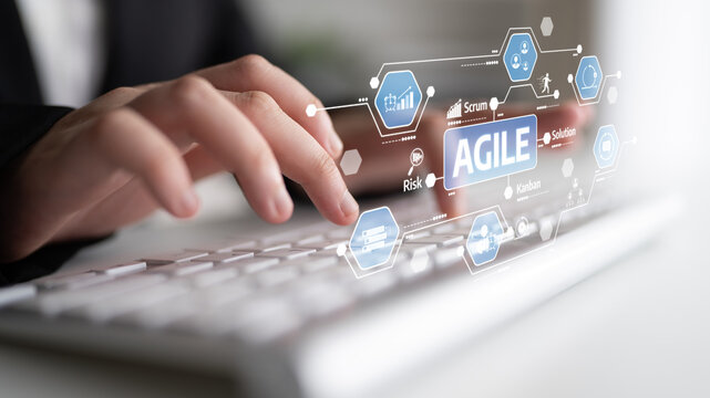 A business professional collaborates using a laptop, highlighting agile methodology concepts such as teamwork, project management, and innovation in a digital workspace. Tessel
