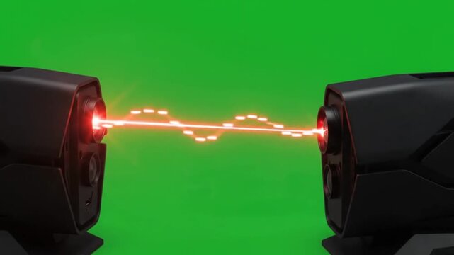 Futuristic devices emit red laser beam across green screen backdrop