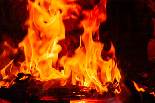 Flames of burning wood inside the fireplace firebox