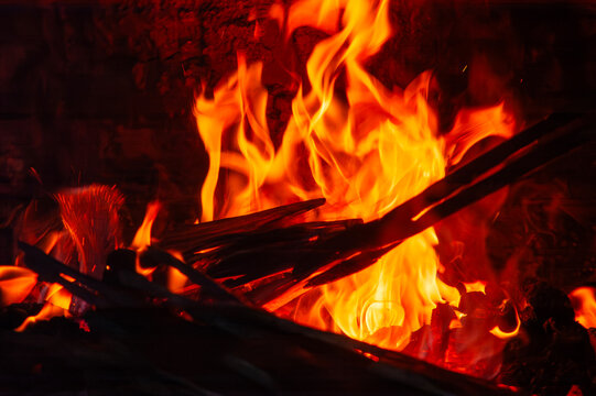 Flames of burning wood inside the fireplace firebox