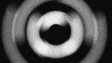 Fototapeta premium Abstract monochromatic circular pattern with grainy texture. Dynamic blurred concentric rings create a modern radial motion background