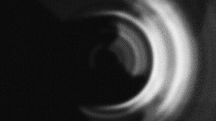 Fototapeta premium Monochromatic concentric rings with a grainy blur texture create a hypnotic radial effect, perfect for abstract motion backgrounds