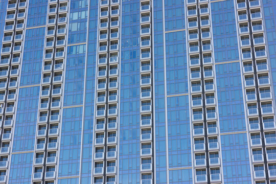Modern skyscraper blue glass window facade pattern detail