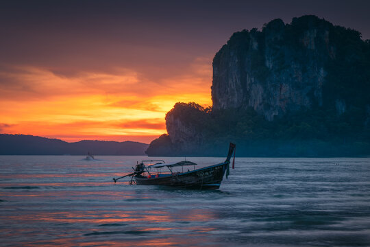Natural scenery of long-tail boats at the seaside at sunset on Railay Beach, Krabi, Thailand