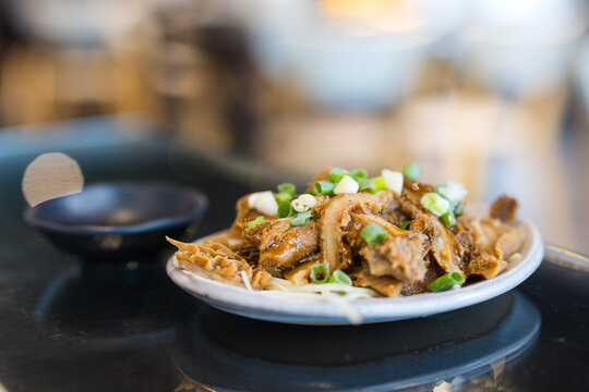 Cooked beef tripe dish garnished with green onions