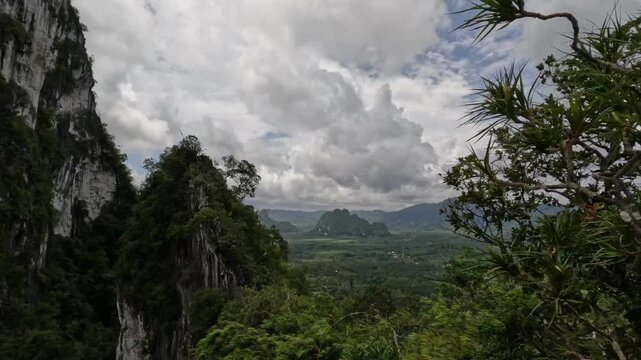 Dramatic panoramic view of tropical limestone mountains and verdant valleys in Chumphon, Thailand.