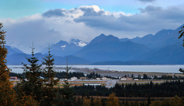 Homer Spit harbor and Kachemak Bay seascape, cloudscape over Kenai Mountains in Alaska, United States