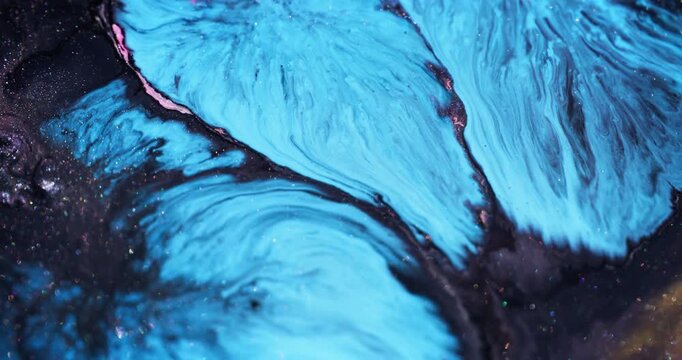 Paint splash. Glitter pigment. Blur blue pink purple color marble blend shiny texture spilling on abstract art creative background.