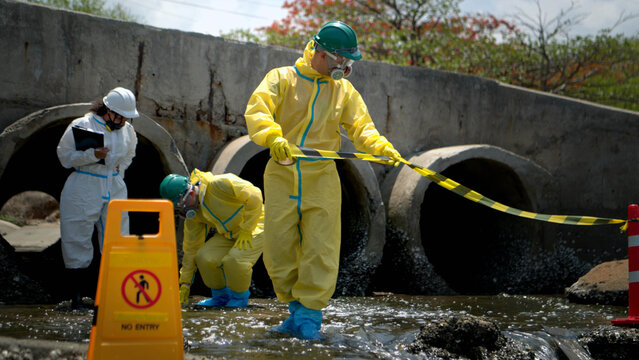 Warning sign and hazardous work area near polluted wastewater drainage tunnel