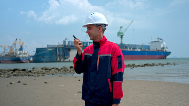 Marine engineer inspecting cargo vessel operations and conducting maritime logistics assessment