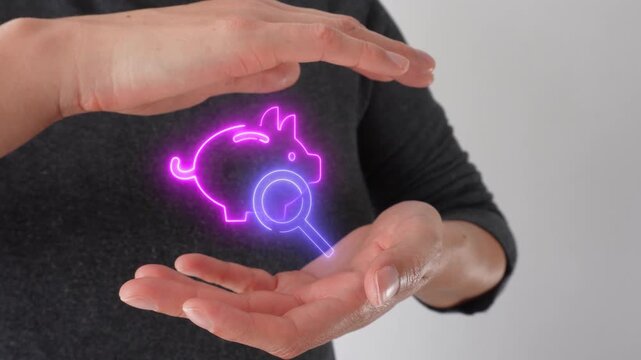Savings optimization. Close-up of a woman's hands cupping a virtual piggy bank icon and a magnifying glass.