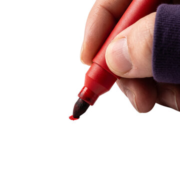 Hand holding a red marker drawing on surface