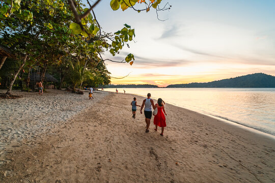family walking on the beach on Bang Bao beach, Koh Chang island
