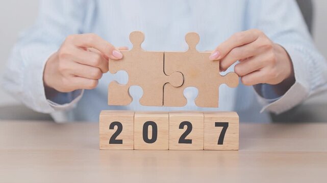 2027 year block with jigsaw puzzle icon. Business Process, Team, teamwork, Goal, mission, Resolution, strategy, plan, Action, partnership, and New Year start