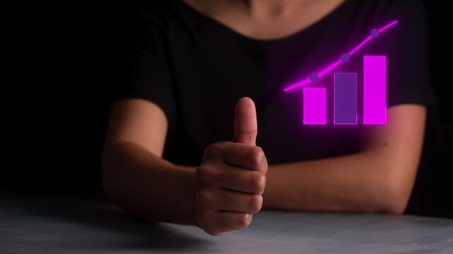 Concept of business success and financial growth with glowing purple chart in thumbs-up hand