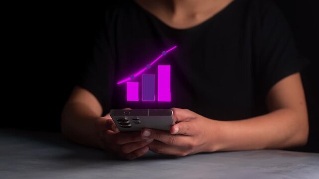 Person using mobile phone with glowing neon bar graph and upward trending line