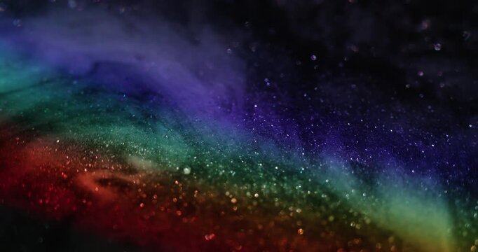Defocused glitter rainbow. Neon light. Blur purple blue pink color illuminated radiant glimmer flash on abstract dark black bokeh background.