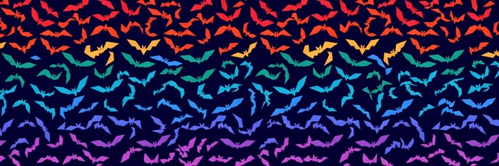Fototapeta premium Colorful geometric Halloween background with triangle bat shapes in a repeating rainbow gradient pattern