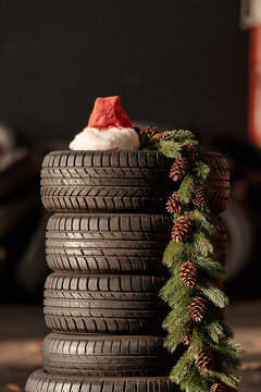 Stack of car tyres adorned with a festive santa hat, showcasing holiday spirit in an unusual way Generative AI
