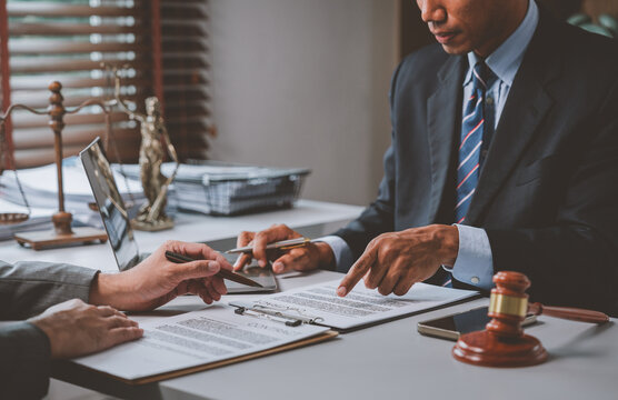 Legal professional meeting with client discussing contract details