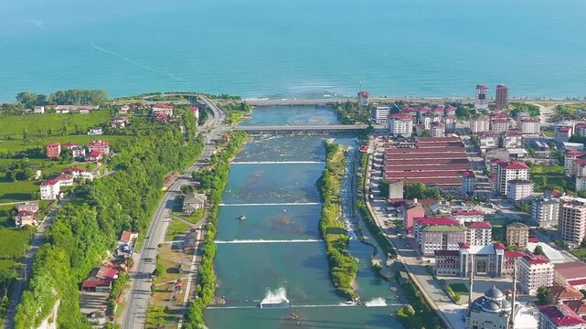 Ardeshen, Turkey. The Firtina River meets the Black Sea, aerial view over the wide estuary, coastal town, and green valley on a bright sunny morning. Aerial View, MasterShots, Zoom In, Circle (Close)