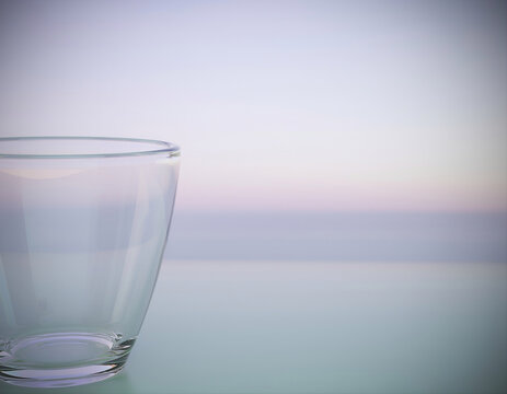 Empty Clear Drinking Glass On Soft Pastel Horizon Background With Copy Space