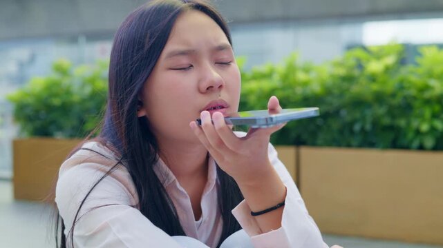 woman talking and command an AI voice assistant on a smartphone as a conceptual backdrop for artificial intelligence technology communication phone innovation virtual assistant and smart lifestyle