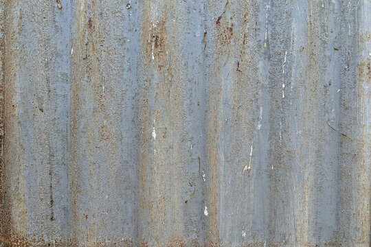 Rusted corrugated metal texture background with weathered zinc surface