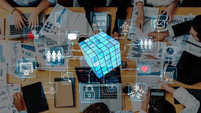A dynamic business meeting setup showcasing technology integration, data visualization, and collaborative teamwork around a modern corporate workspace. Entropy.
