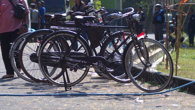 Row of Classic Vintage Onthel Bicycles Parked on the Roadside for Community Gathering