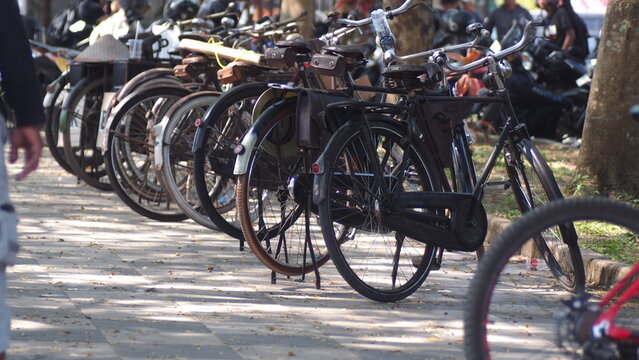 Row of Classic Vintage Onthel Bicycles Parked on the Roadside for Community Gathering