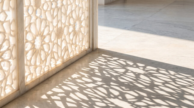 White marble intricate lattice screen casts geometric shadows onto polished stone floor in bright daylight sunshine