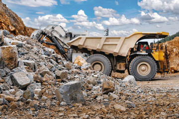 Heavy dump truck at rock pile in active quarry for mining industry background and construction equipment © Parilov
