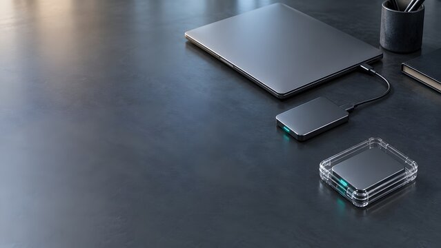 Laptop connected to portable drive beside protected storage device