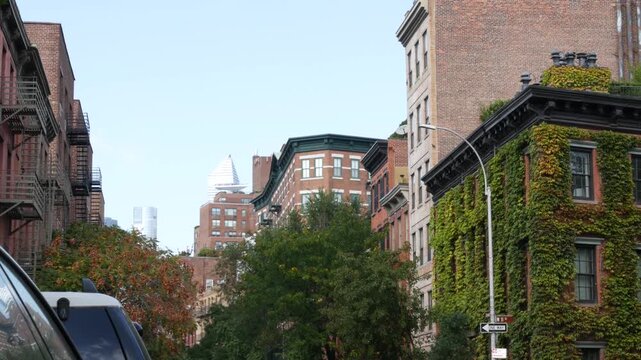 New York City urban residential buildings architecture, Lower Manhattan West village Greenwich street corner, United States of America. Greenwich village, USA. Red brick house. Vine greenery on wall.