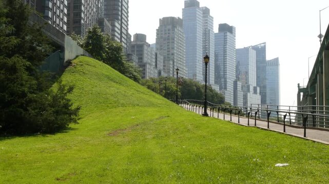 New York City Riverside Park South, Manhattan, United States. Modern residential buildings in Upper West Side. Urban skyscraper skyline, luxury apartments, condos. Summer green grass lawn, riverfront.