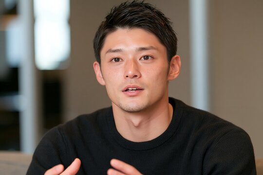 ビジネスミーティングで熱心に説明する若い日本人男性