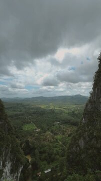 Panoramic View of Lush Green Tropical Valley and Towering Limestone Cliffs in Chumphon, Thailand