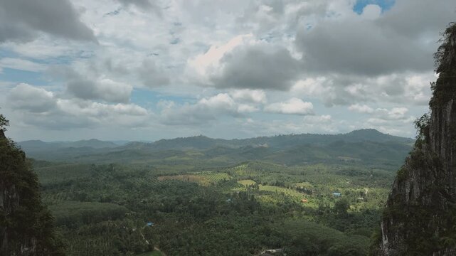 Expansive panoramic view of lush green mountains and dense tropical forests in Chumphon, Thailand.