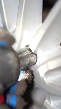 Wheel Hub Removal Process Using Impact Wrench, This video clip shows a close-up sequence capturing the meticulous process of removing a wheel hub from an automotive tire