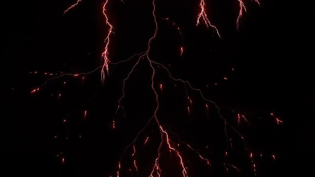 Crimson lightning strike across dark sky during stormy night with powerful electrical discharge