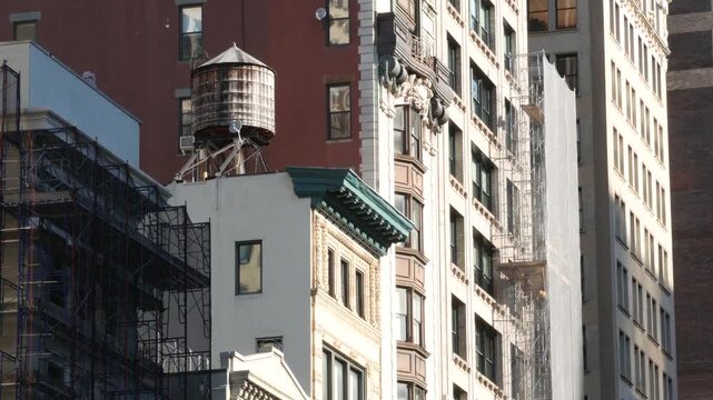 New York City urban building architecture, Manhattan rooftop, United States of America. Water tower on roof. Classic water tanks.
