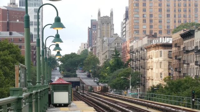 New York City Upper Manhattan subway outdoor station platform, 125 street elevated metro in Harlem, United States railway. Residential district public metropolitan transport. Lanterns and buildings.